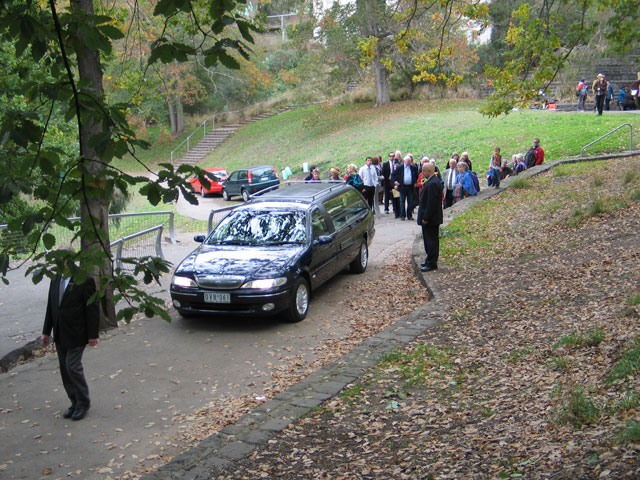 the hearse pulls away, Yoland carries the scarf